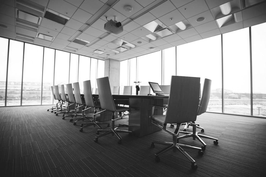A bright, empty meeting room with a long table